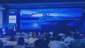 The audience at the Banking Tech Summit Honduras in front of the CLAI PAYMENTS® Technologies stage during a presentation on digital payments and technology integration.